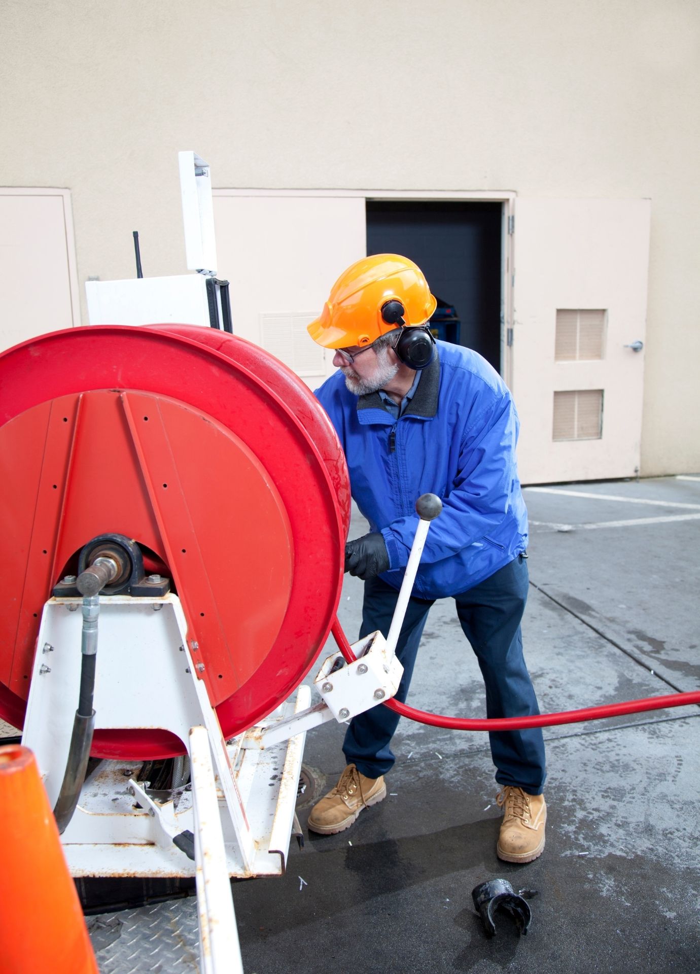 Technician operating professional drain cleaning equipment